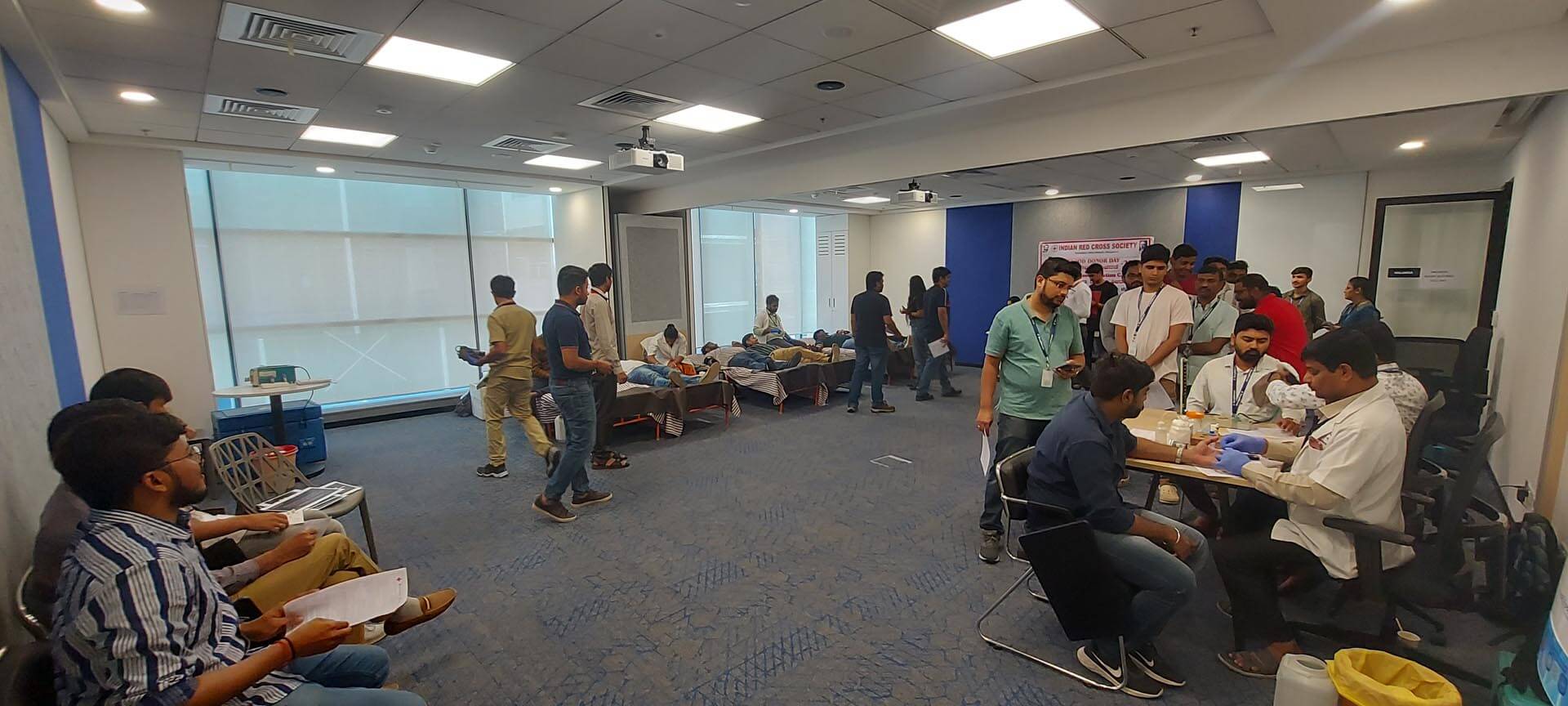 a group of people in a room donating blood