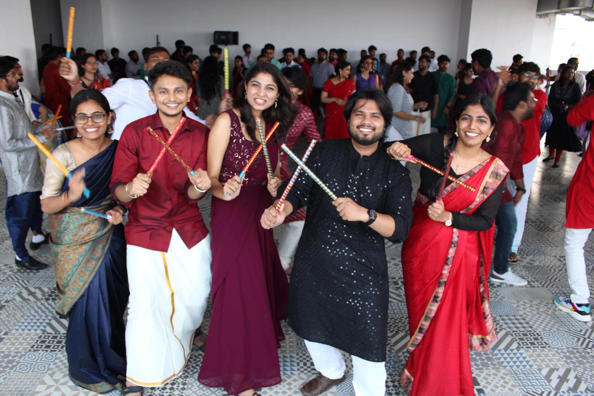 a group of people holding sticks