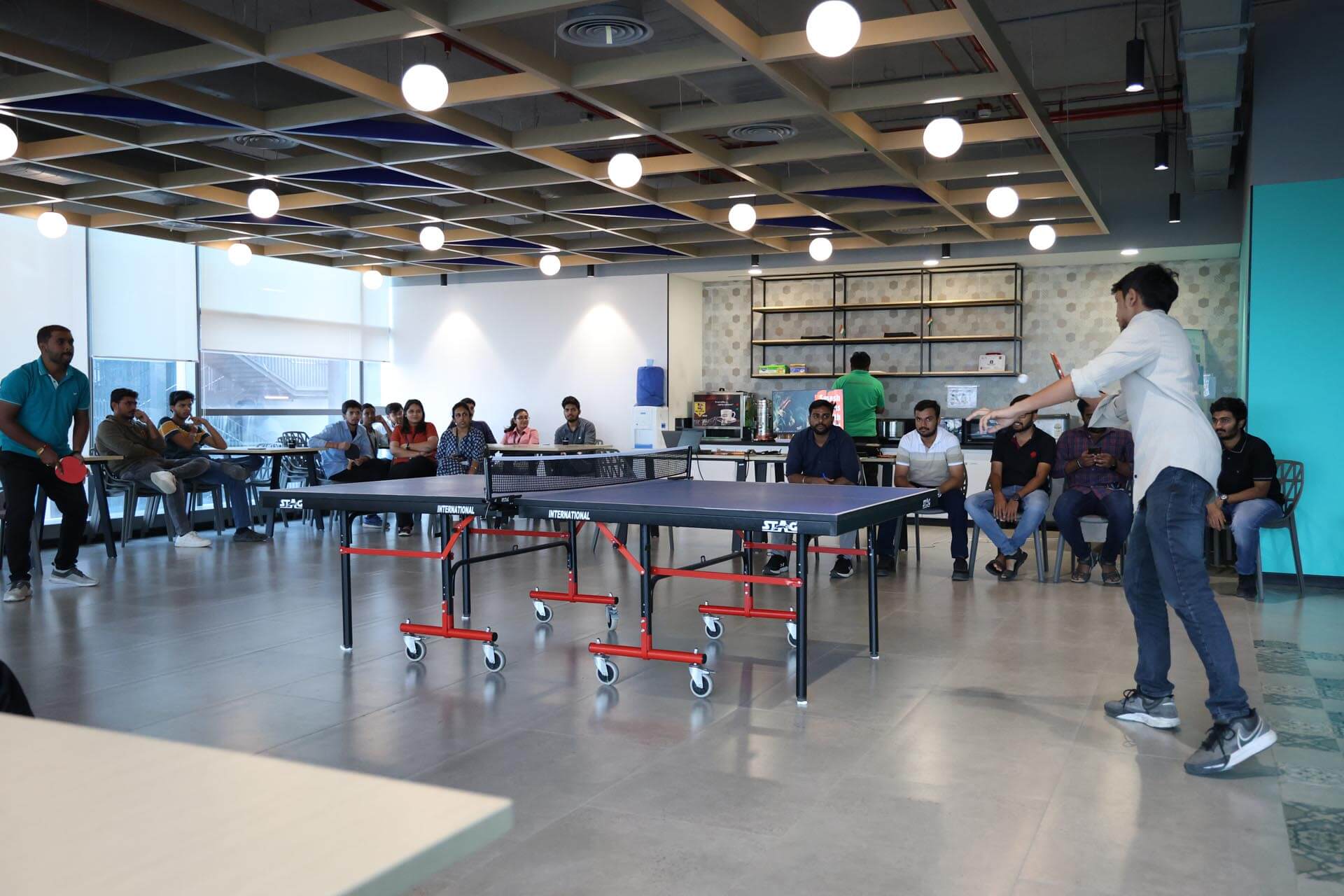 a person standing in front of a table tennis table