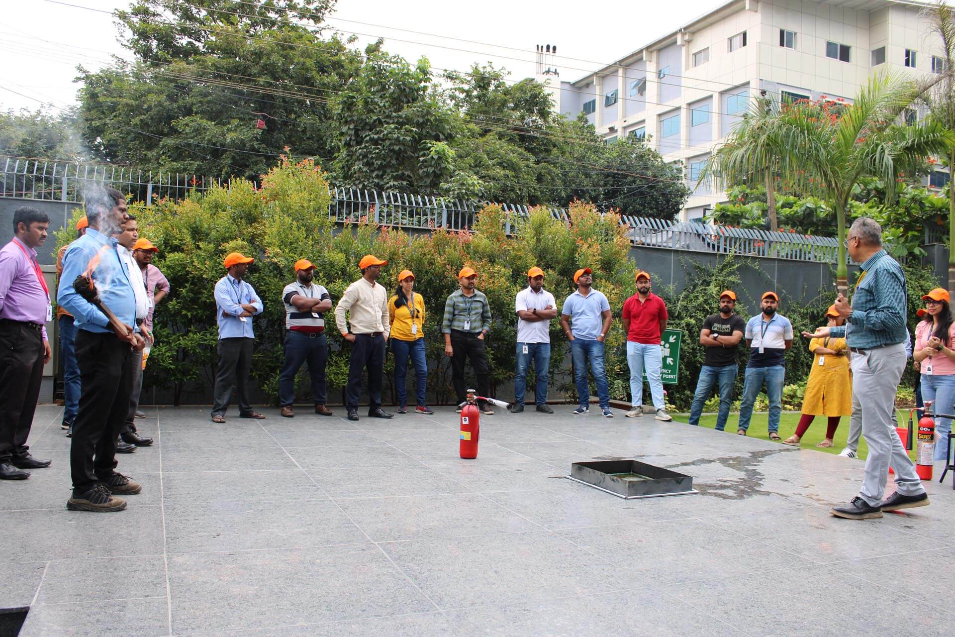 a group of people standing in front of a fire extinguisher