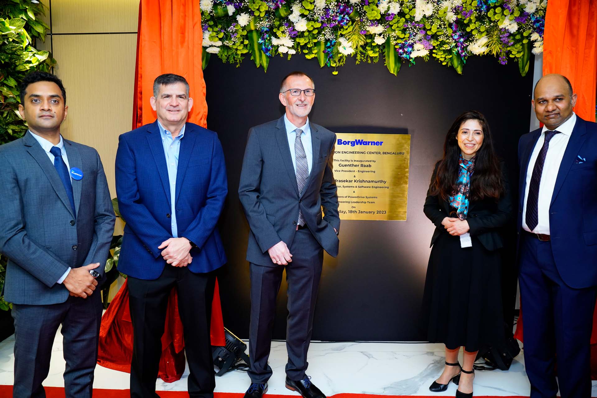 Four people standing in front of sign at the IPEC Unveiling Event