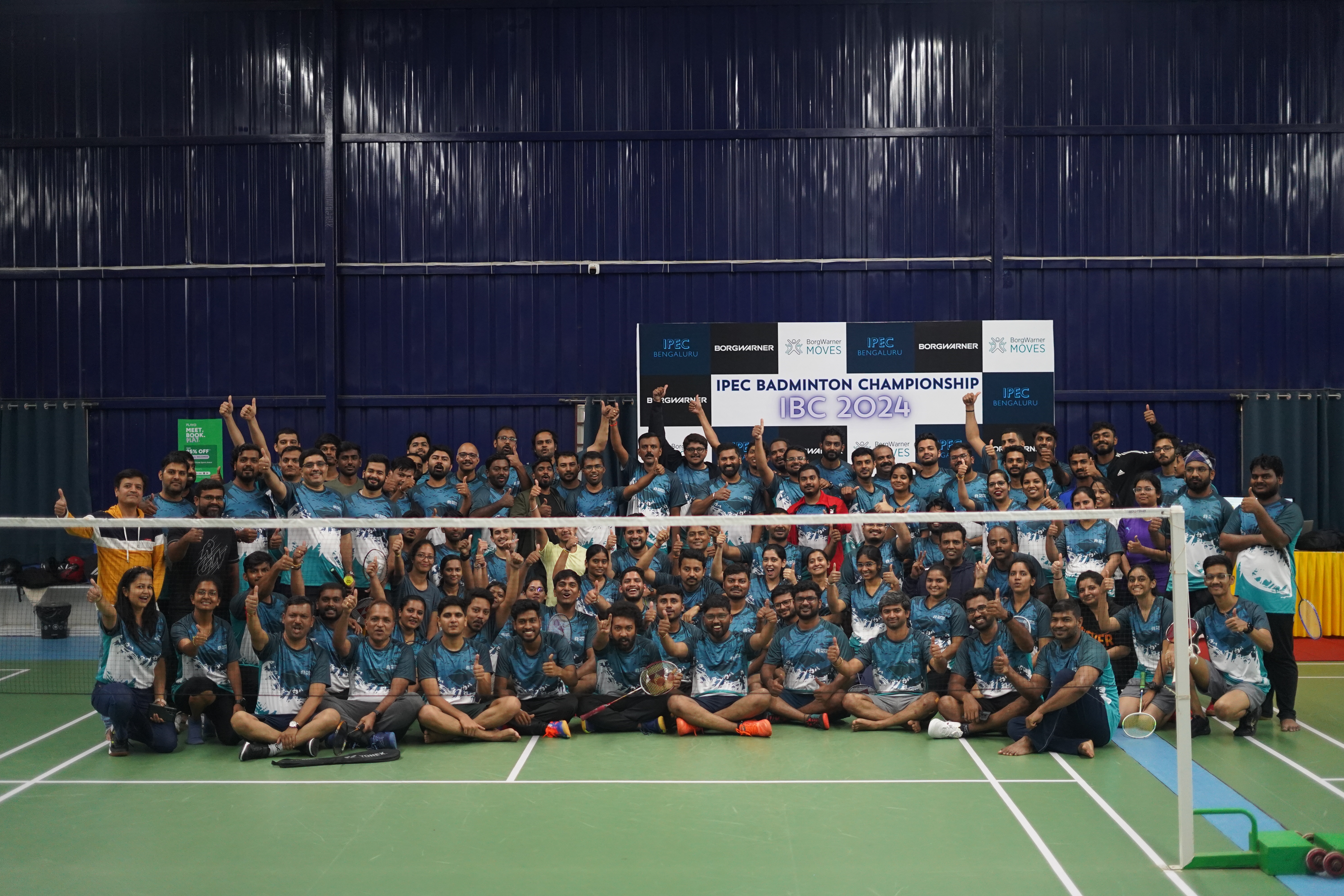 Group photo with badminton sign