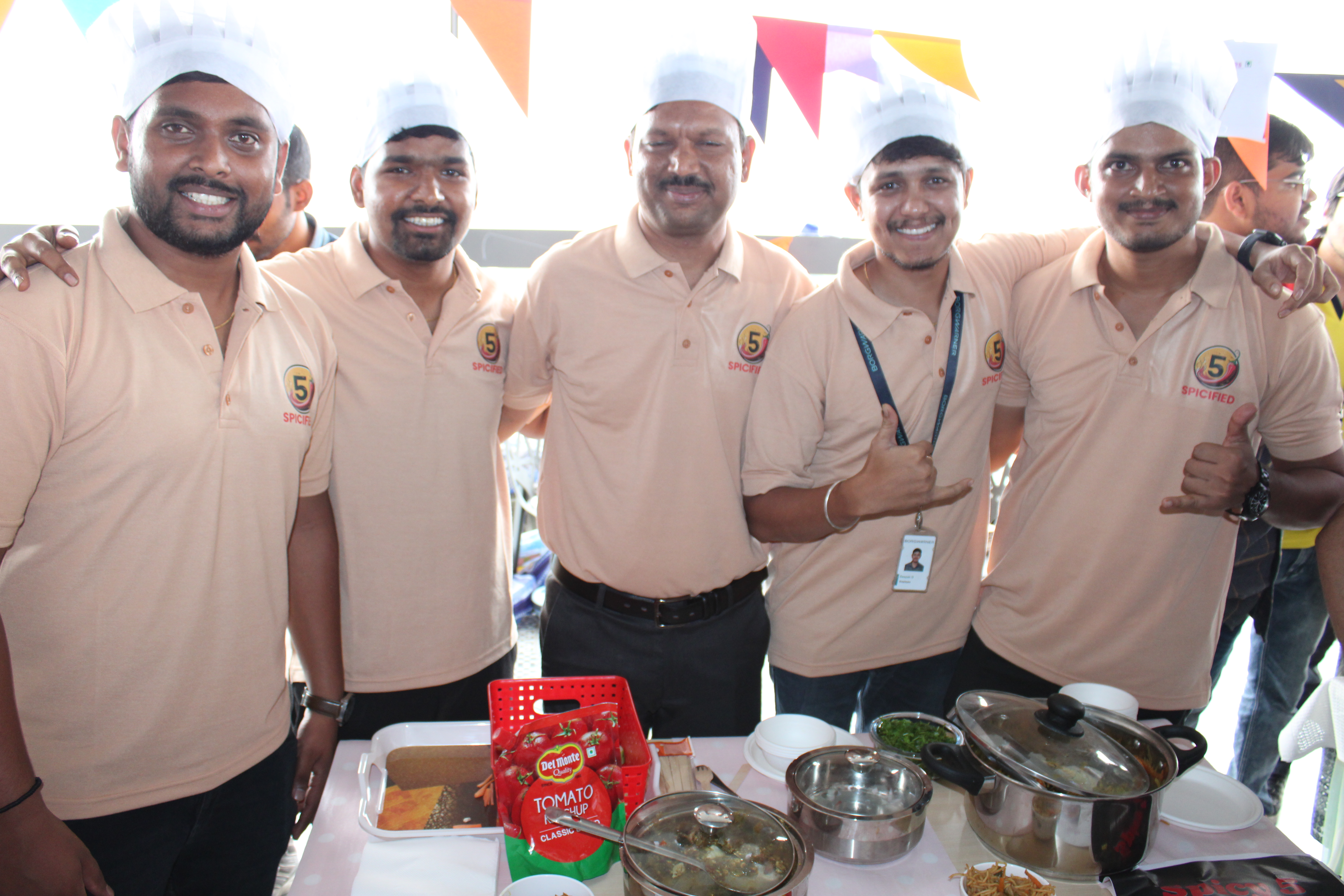 Group wearing chefs hats smiling