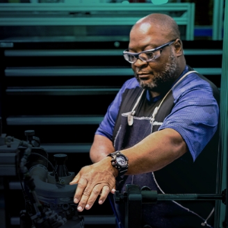An experienced technician working at a manufacturing line