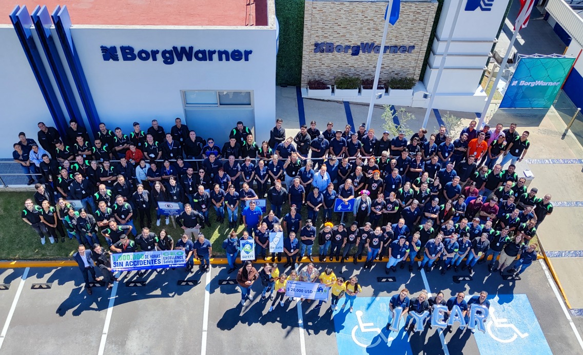 a group of people standing in a parking lot