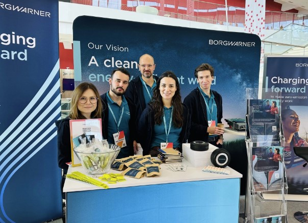 a group of people standing in front of a sign