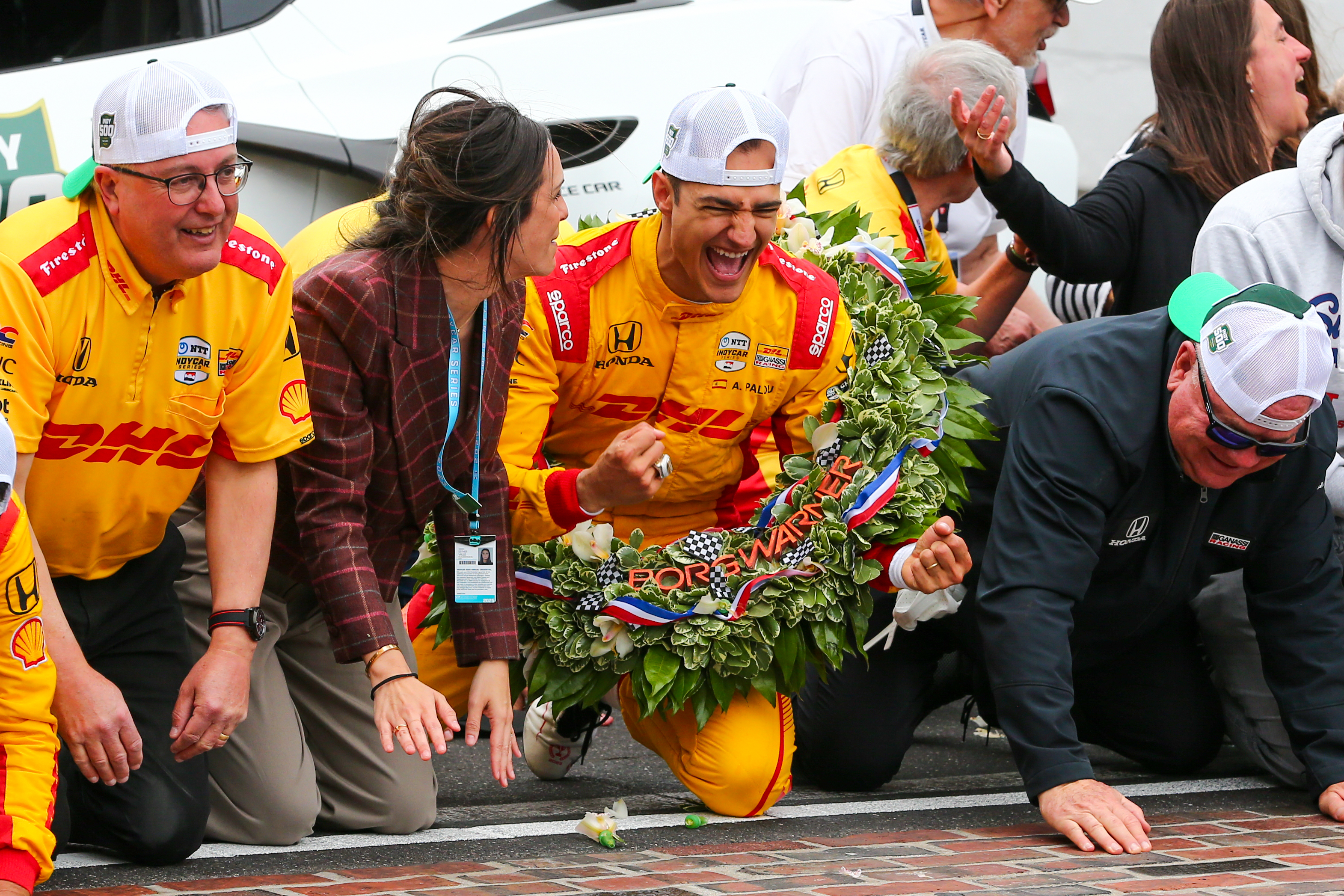 2025 Indy 500 Winner Alex Palou and team kiss the bricks