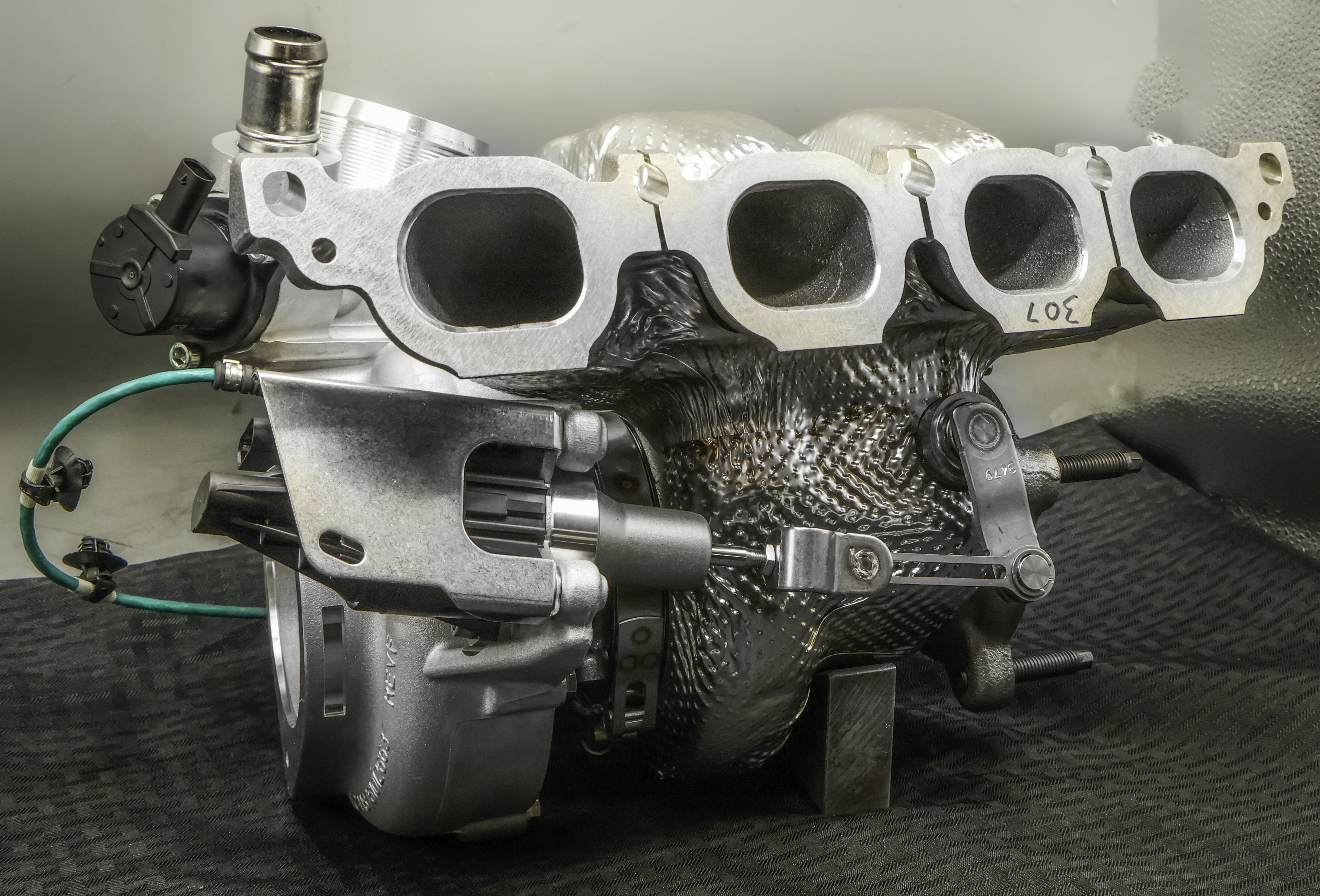 Large silver turbocharger with hose