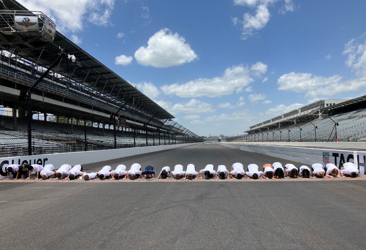People kissing the bricks at Indiana Motor Speedway