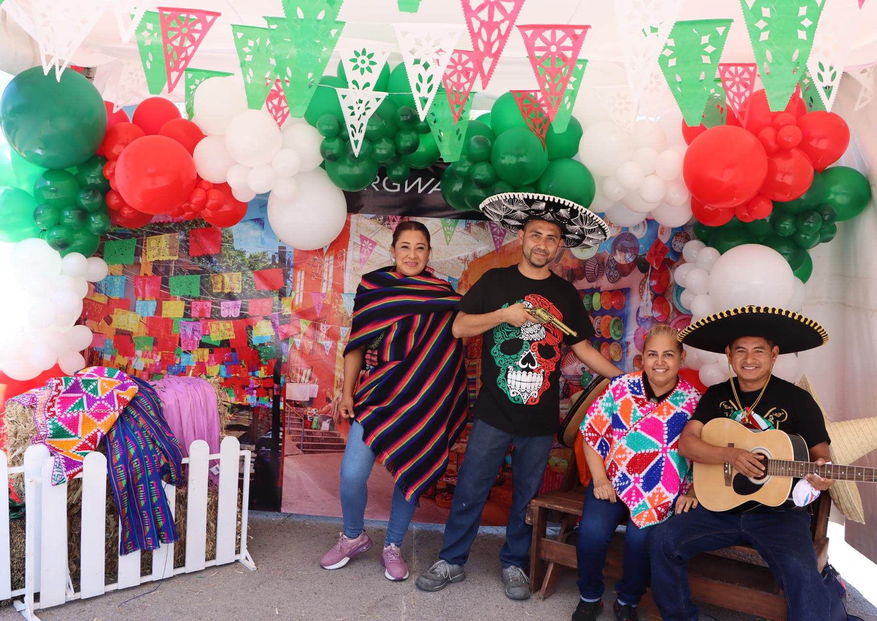 a group of people posing for a photo under a canopy