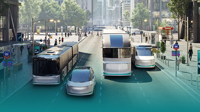 A bus, a car, a truck and a van driving on a street in a city center