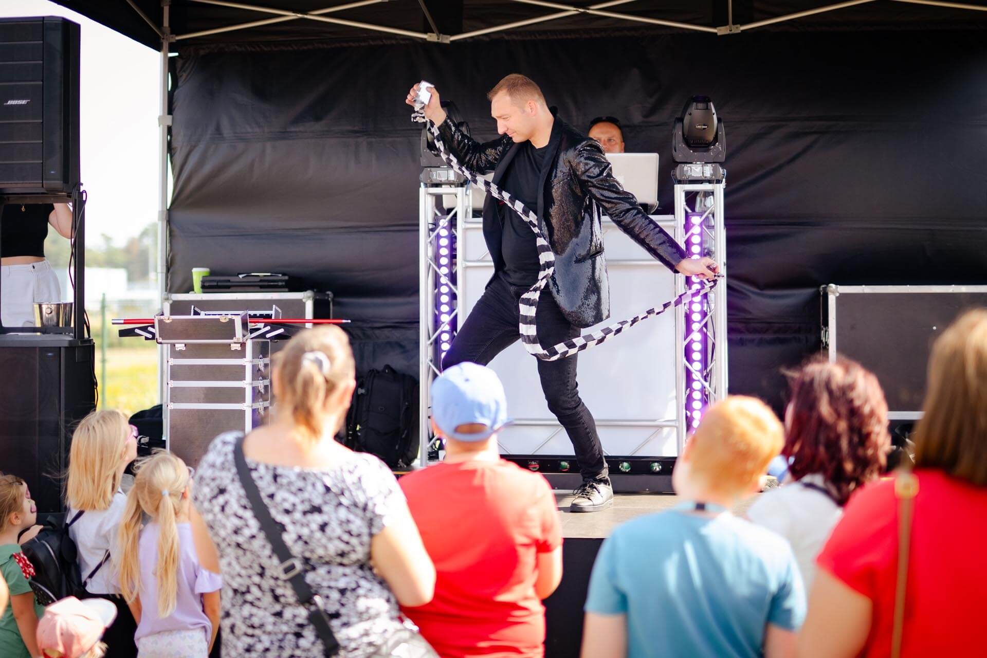 a man on stage with a rope